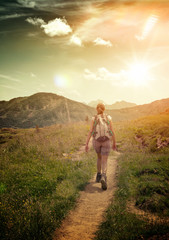Wall Mural - Woman Hiking on Remote Mountain Valley Trail
