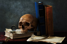 Still Life Art Photography On Human Skull Skeleton With Book Omn Desk