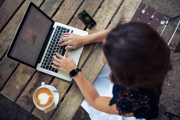 Woman using her laptop at a coffee shop