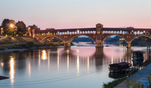 Pavia, Italy: Covered Bridge Over The River Ticino At Sunset