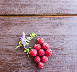 Wall Mural - Fresh raspberries on a wooden table