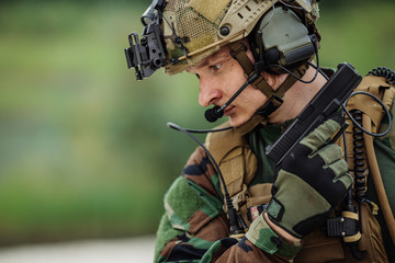 Wall Mural - portrait of soldier with canadian camouflage pointing with pisto