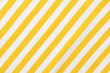 Wall Mural - White and yellow striped background. Diagonal stripes pattern on fabric.