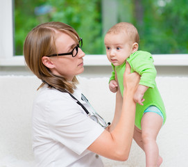 Sticker - doctor examining a newborn baby