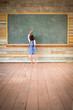 © PathomP - Little girl clear the old green chalkboard