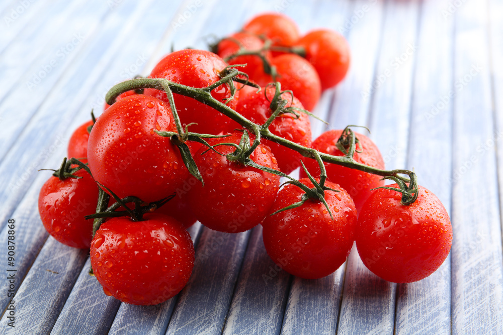 Fresh cherry tomatoes on wooden table close up