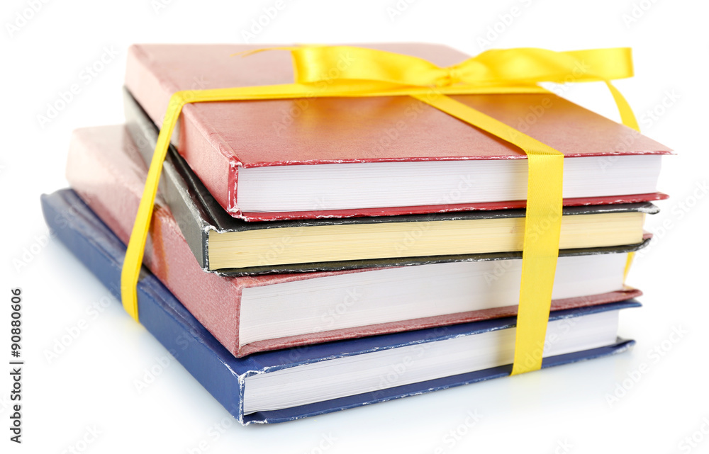 Stack of books with ribbon isolated on white