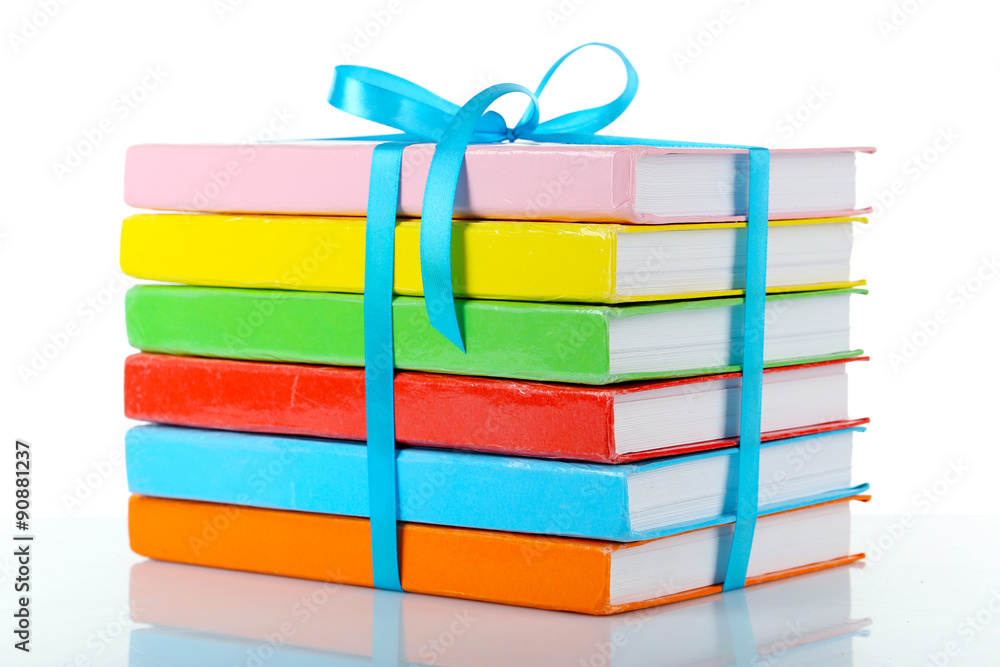 Stack of books with ribbon isolated on white