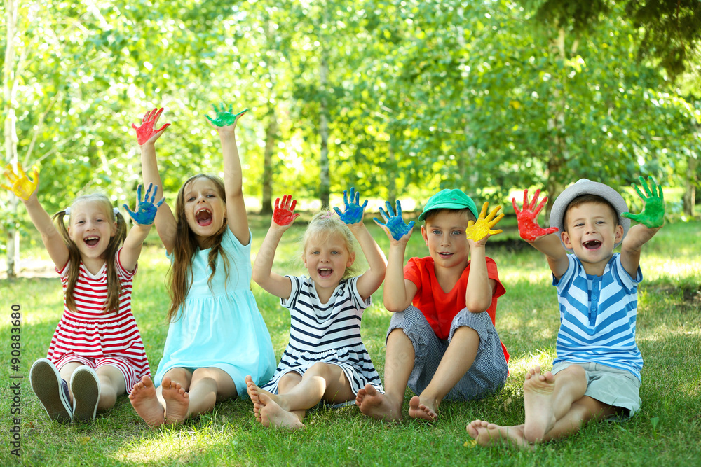 Happy active children with bright colored palms in park