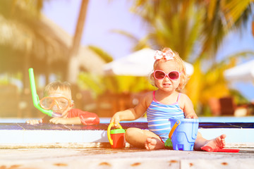 Wall Mural - little boy and girl playing in swimming pool at beach