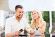 © Syda Productions - happy couple with bank card and bill at restaurant