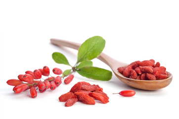 Wall Mural - Fresh berberries near heap of goji berries  and wooden spoon wit