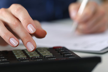 Close up of female accountant or banker making calculations