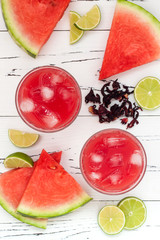 Wall Mural - Watermelon, hibiscus, lime cooler - refreshing summer  drink with lime and mint. Top view