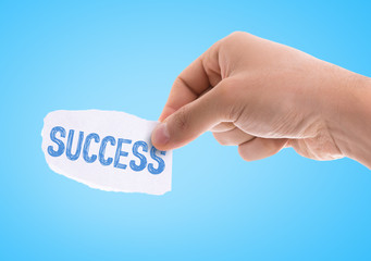 Wall Mural - piece of paper with the word success with blue background