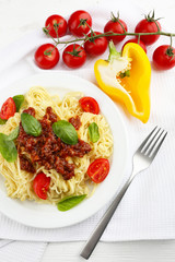 Sticker - Spaghetti Bolognese on white plate, on color wooden background