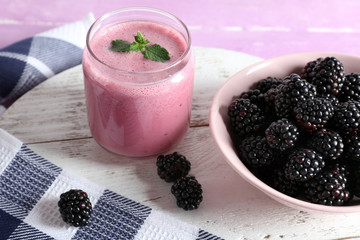 Poster - Delicious berry smoothie with blackberries on table close up