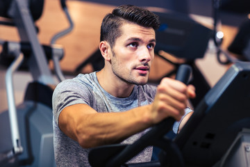 Sticker - Man workout on a fitness machine at gym