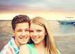 © Syda Productions - smiling couple hugging over beach background