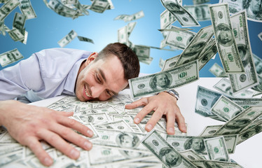 happy businessman with heap of money