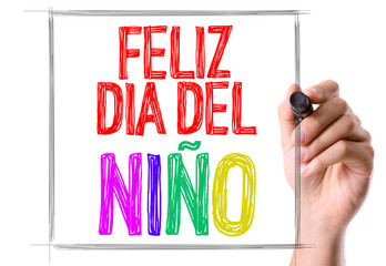 Hand with marker writing the text Happy Childrens Day (in Spanish)