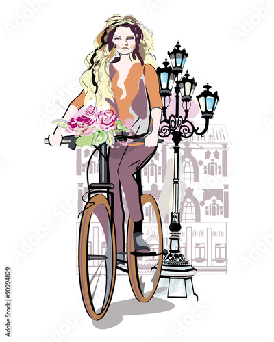 Naklejka dekoracyjna Fashion girl rides a bicycle the streets of the old town. Hand drawn illustration. 