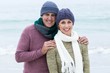 © WavebreakmediaMicro - Smiling happy couple both wearing scarfs and hats