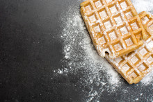 Waffles with sugar on slate table