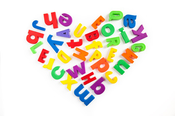 Heart shape made of colorful magnetic fridge letters.