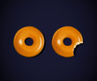 Donut and donut with a mouth bite isolated on dark background (teeth)