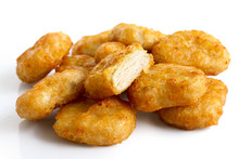 Pile Of Golden Deep-fried Battered Chicken Nuggets Isolated On W