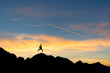 © catgrig - hiker on the peak at sunset