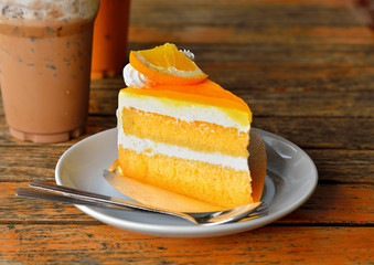 Poster - Orange cake and cold coco on wooden background