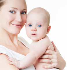 Mother and baby playing and smiling. Happy family.