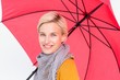 © WavebreakmediaMicro - Smiling woman holding an umbrella