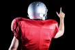 © WavebreakmediaMicro - Rear view of American football player pointing