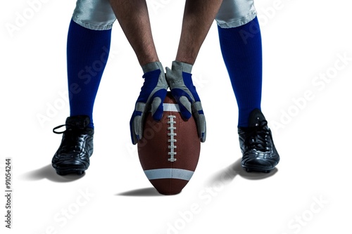 Fotografiet Low section of American football player placing ball