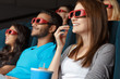 © LENSLOGIC - Friends watching 3D movie in the cinema