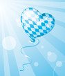 Oktoberfest heart balloon in Bavarian colors flying in the sky