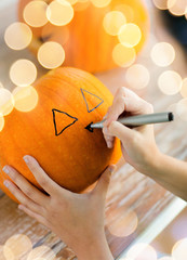 Wall Mural - close up of woman with pumpkins at home