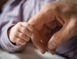 © shara - Father finger and newborn baby hand