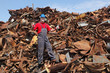 © sima - Recycling industry, worker gesture at heap of old scrap metal