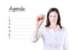 Young business woman writing blank agenda list, white background.  