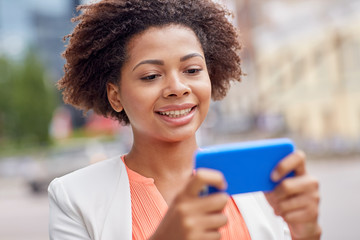 Poster - happy african businesswoman with smartphone