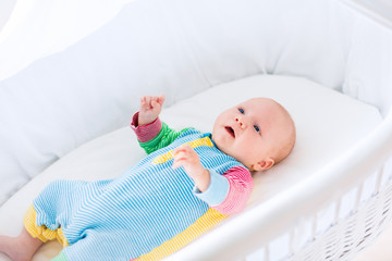Wall Mural - cute baby boy in a white crib