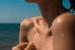 beautiful female shoulder without bikini on tropical beach