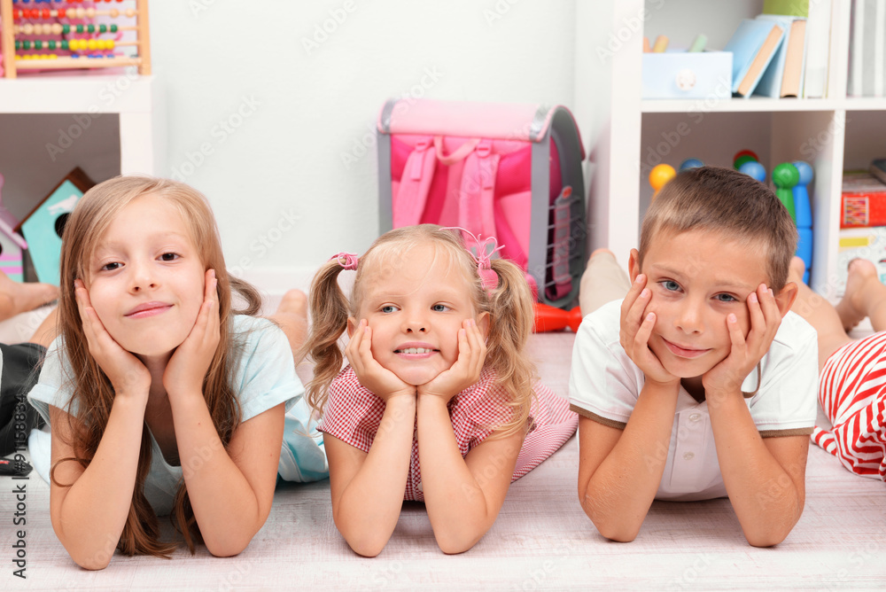 Row of children on floor in classroom