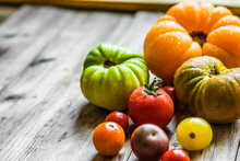 Colorful Heirloom Tomatoes On Rustic Wooden Background