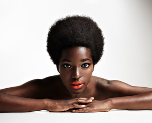 Wall Mural - black woman lying down and watching at camera