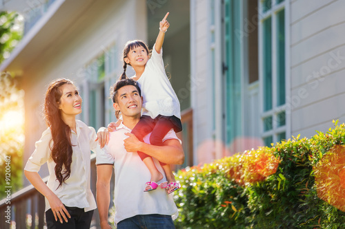 Fotografia, Obraz Beautiful family portrait smiling outside their new house